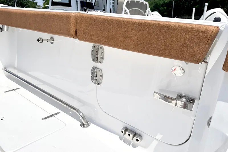 Slide: The Image of 2027 Sea Hunt Ultra 275 SE boat interior detail with brown cushioned seating and stainless steel fittings. - 4