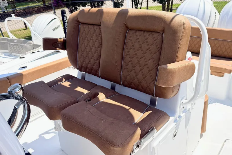 Slide: The Image of Brown cushioned seating on 2027 Sea Hunt Ultra 275 SE boat, featuring diamond stitching. - 14