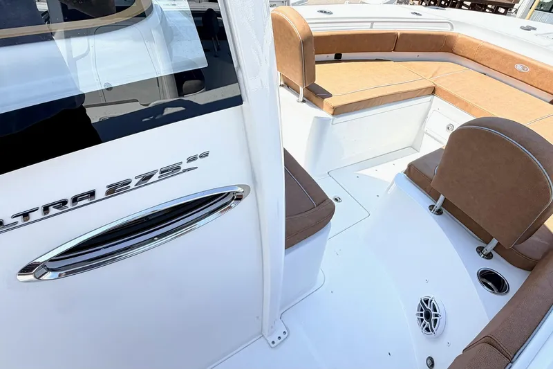 Slide: The Image of 2027 Sea Hunt Ultra 275 SE boat interior with brown seating and sleek design. - 21