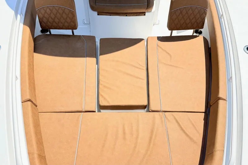 Slide: The Image of 2027 Sea Hunt Ultra 275 SE boat interior with tan cushioned seating. - 30