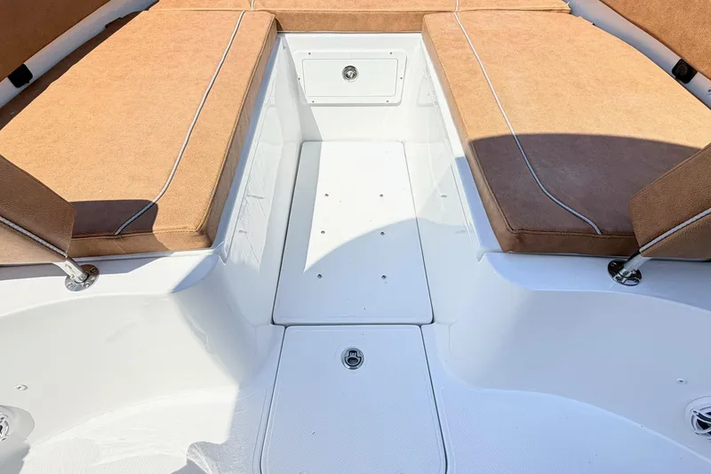 Slide: The Image of Interior seating of 2027 Sea Hunt Ultra 275 SE boat with tan cushions. - 19