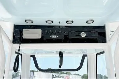 Slide: The Image of 2027 Sea Hunt Ultra 245 SE boat console with modern controls and marine electronics. - 12