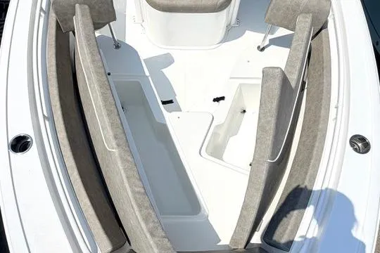Slide: The Image of 2027 Sea Hunt Ultra 245 SE boat interior with cushioned seating and storage compartments. - 31
