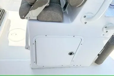 Slide: The Image of 2027 Sea Hunt Ultra 245 SE boat interior with seating and storage compartment. - 16