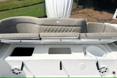 Slide: The Image of 2027 Sea Hunt Ultra 245 SE boat interior with cushioned seating and storage compartments. - 6