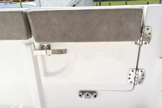 Slide: The Image of 2027 Sea Hunt Ultra 245 SE boat interior, featuring a cushioned seat and stainless steel hardware. - 20