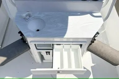 Slide: The Image of 2027 Sea Hunt Ultra 245 SE boat interior with storage compartments and seating. - 7