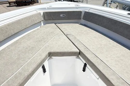 Slide: The Image of 2027 Sea Hunt Ultra 245 SE boat with spacious cushioned seating area. - 25