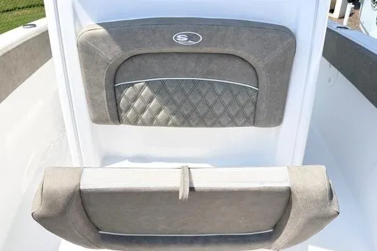 Slide: The Image of 2027 Sea Hunt Ultra 245 SE boat interior with cushioned seating and diamond-patterned upholstery. - 28