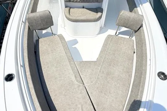 Slide: The Image of 2027 Sea Hunt Ultra 245 SE boat interior with cushioned seating and sleek design. - 30