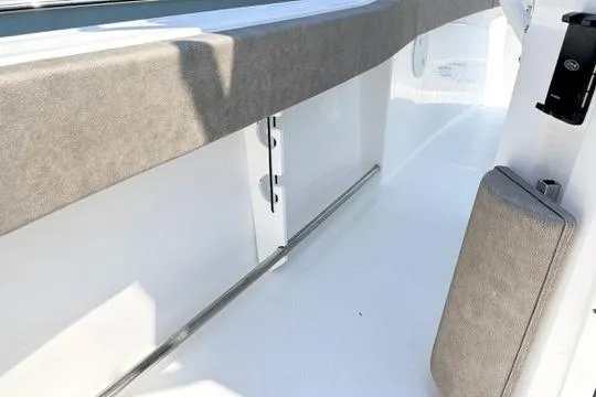 Slide: The Image of 2027 Sea Hunt Ultra 245 SE boat interior with cushioned seating and sleek design. - 21