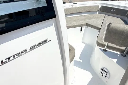 Slide: The Image of 2027 Sea Hunt Ultra 245 SE boat interior with cushioned seating and sleek design. - 24