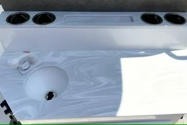 Slide: The Image of 2027 Sea Hunt Ultra 245 SE boat console with cup holders and sink. - 8