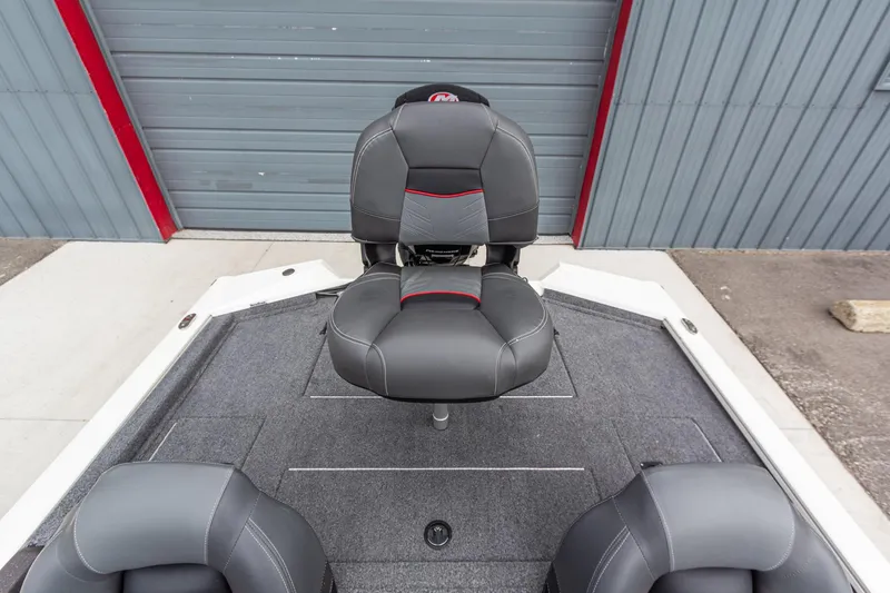 Slide: The Image of 2023 Tracker Pro Team 190 TX boat seat, gray upholstery, red accents, on deck. - 12