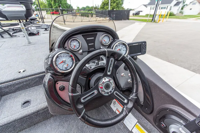 Slide: The Image of 2023 Tracker Pro Team 190 TX boat dashboard with steering wheel and gauges. - 18
