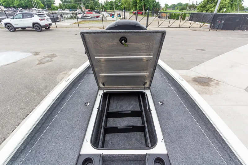 Slide: The Image of 2023 Tracker Pro Team 190 TX boat storage compartment open, showcasing spacious interior. - 24