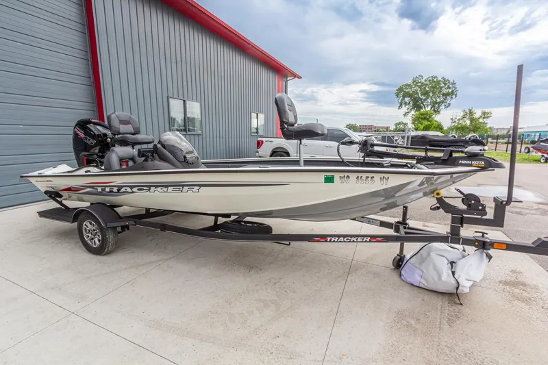 Slide: The Image of 2023 Tracker Pro Team 190 TX fishing boat on trailer, parked outside a building. - 9