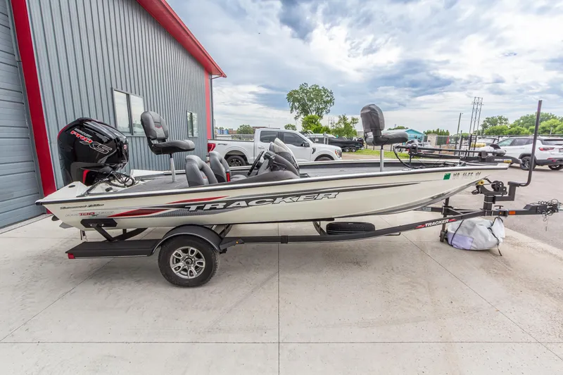 Slide: The Image of 2023 Tracker Pro Team 190 TX boat on trailer, parked outside a building. - 8