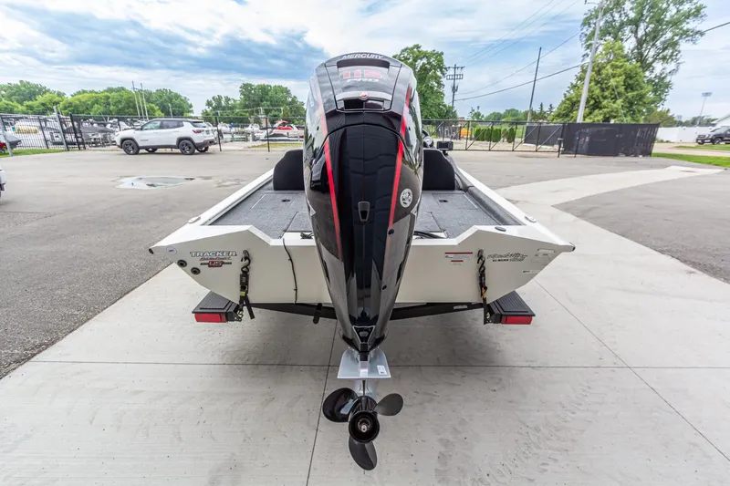 Slide: The Image of 2023 Tracker Pro Team 190 TX boat with powerful outboard motor, parked outdoors. - 5