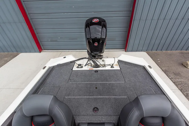 Slide: The Image of 2023 Tracker Pro Team 190 TX boat interior with motor, gray carpet, and seating. - 13