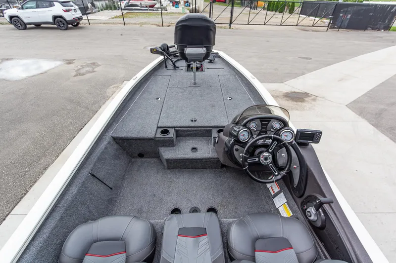 Slide: The Image of 2023 Tracker Pro Team 190 TX boat interior with steering console and seating. - 15