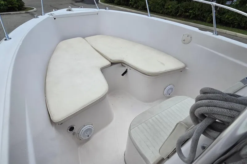 Slide: The Image of 1994 Grady-White Chase 263 boat interior with cushioned seating and coiled rope. - 7