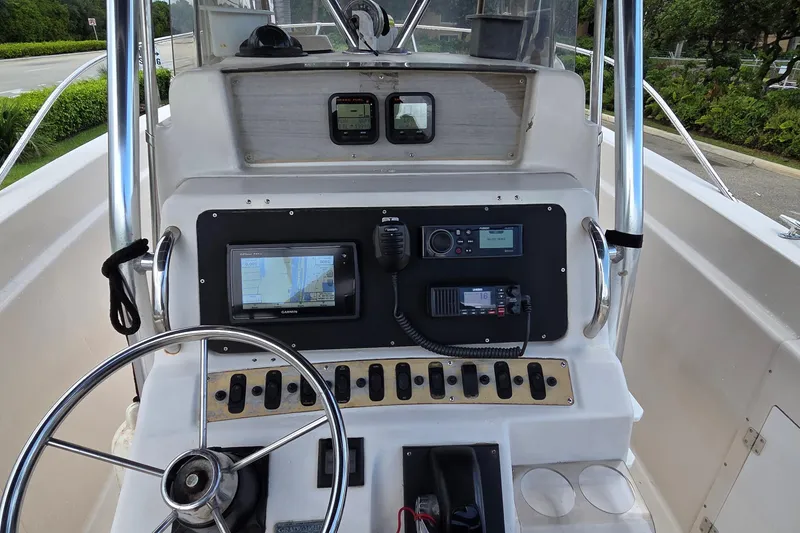 Slide: The Image of 1994 Grady-White Chase 263 boat dashboard with steering wheel and navigation equipment. - 10