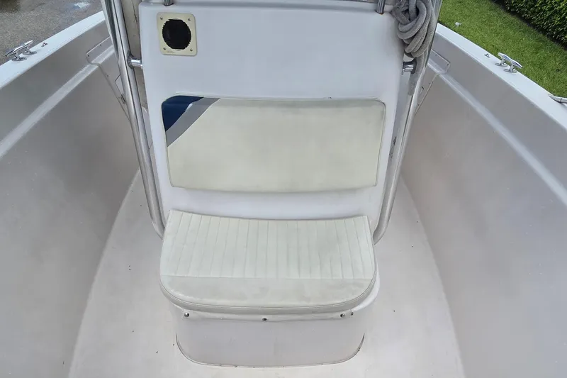 Slide: The Image of 1994 Grady-White Chase 263 boat interior with cushioned seating and clean white surfaces. - 9