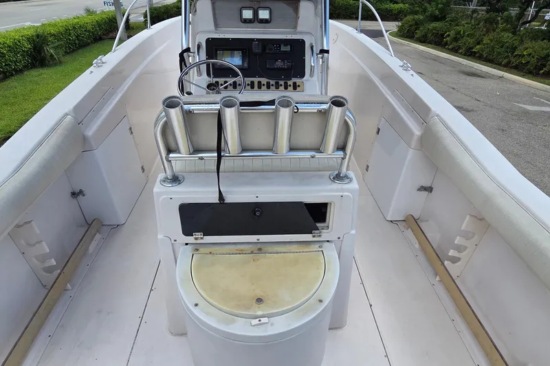 Slide: The Image of 1994 Grady-White Chase 263 boat interior with steering console and rod holders. - 11