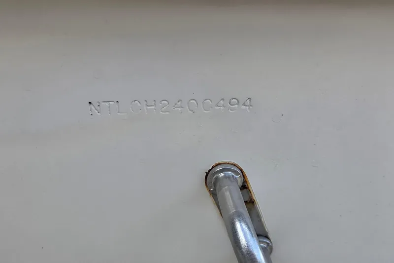 Slide: The Image of 1994 Grady-White Chase 263 boat hull identification number and metal fitting. - 17