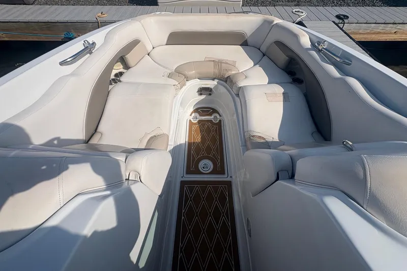 Slide: The Image of 2013 Crownline Eclipse E6 boat interior with white seating and wooden flooring. - 7