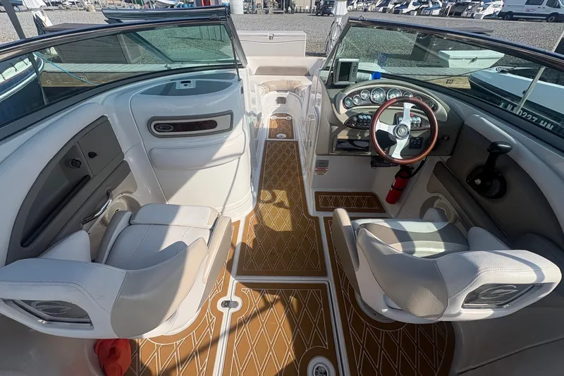 Slide: The Image of 2013 Crownline Eclipse E6 boat interior with steering wheel, dashboard, and seating. - 5