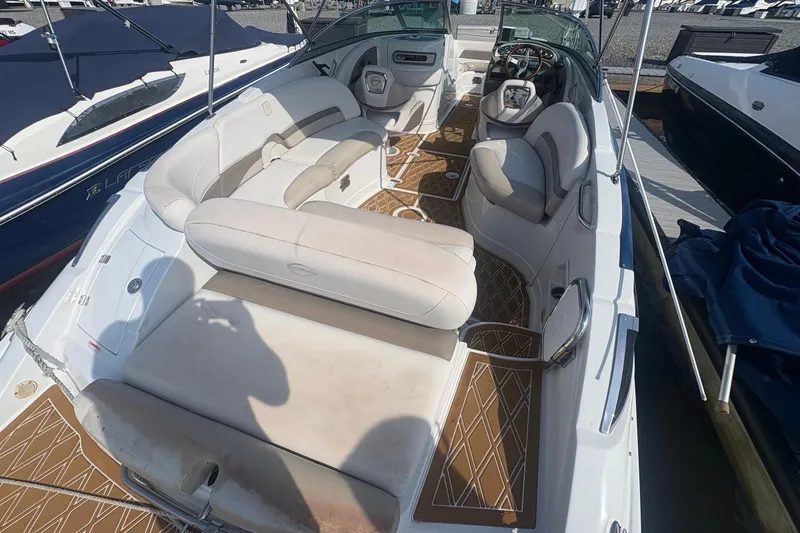 Slide: The Image of 2013 Crownline Eclipse E6 boat interior with beige seating and brown flooring. - 3