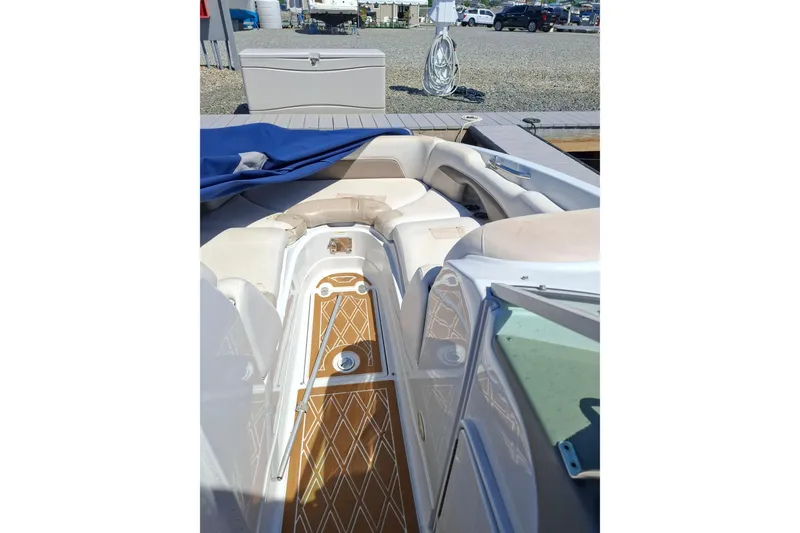 Slide: The Image of 2013 Crownline Eclipse E6 boat interior with cushioned seating and wooden flooring. - 10