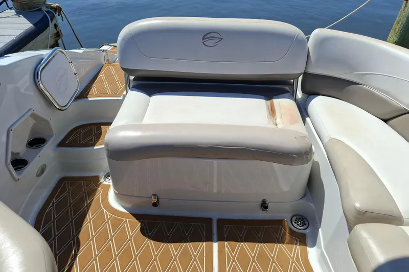 Slide: The Image of 2013 Crownline Eclipse E6 boat interior with cushioned seating and patterned flooring. - 6