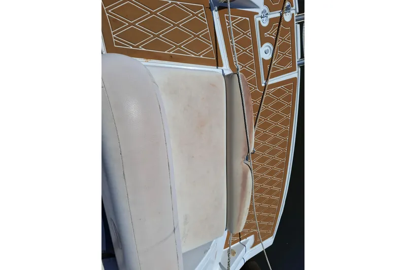 Slide: The Image of 2013 Crownline Eclipse E6 boat interior with tan upholstery and diamond-patterned flooring. - 4