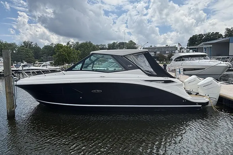 The Image of 2024 Sea Ray Sundancer 320 Outboard docked at marina under cloudy sky. - 16