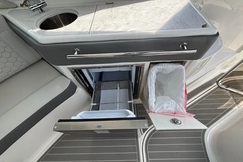Slide: The Image of 2024 Sea Ray Sundancer 320 Outboard galley with sink, storage, and trash compartment. - 26