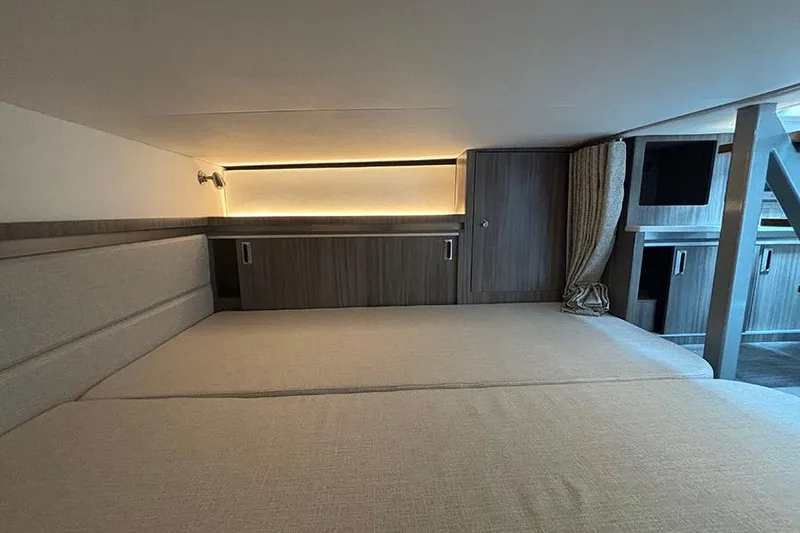 Slide: The Image of 2024 Sea Ray Sundancer 320 Outboard cabin interior with modern wood finishes and ambient lighting. - 37
