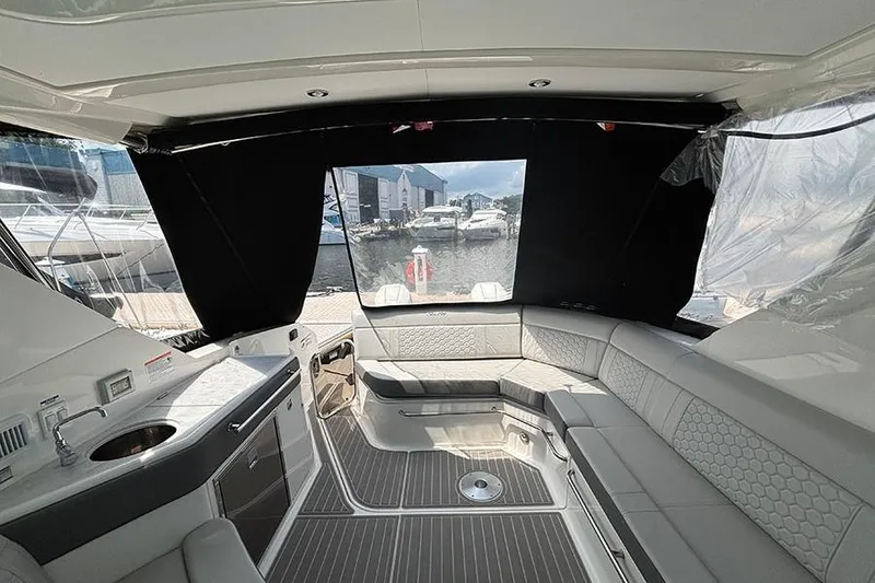 Slide: The Image of Luxurious interior of 2024 Sea Ray Sundancer 320 Outboard, featuring elegant seating and modern amenities. - 21