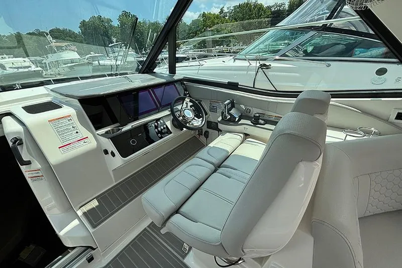 Slide: The Image of 2024 Sea Ray Sundancer 320 Outboard cockpit with modern controls and comfortable seating. - 28