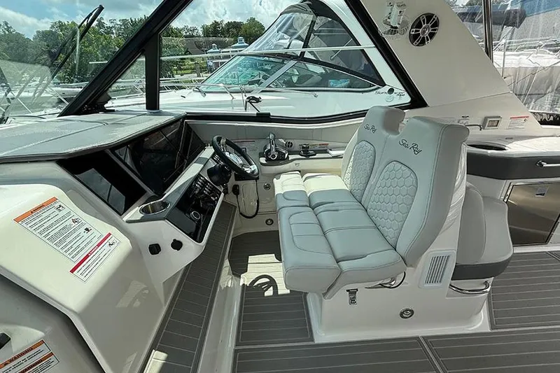 Slide: The Image of 2024 Sea Ray Sundancer 320 Outboard cockpit with modern helm and plush seating. - 29
