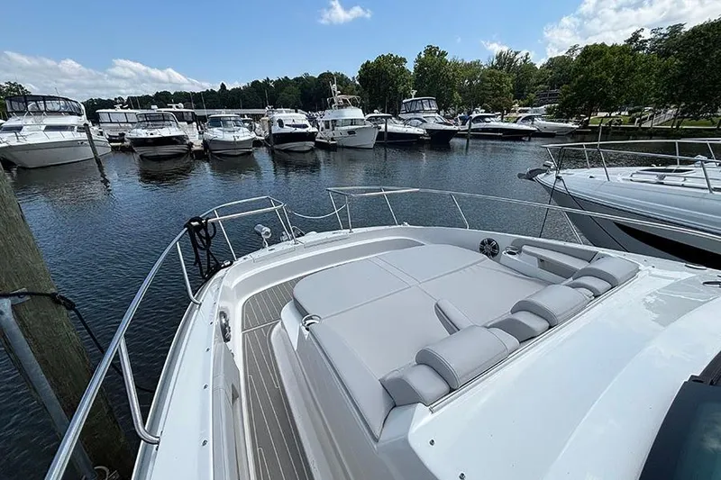 Slide: The Image of 2024 Sea Ray Sundancer 320 Outboard docked at marina with other boats. - 39