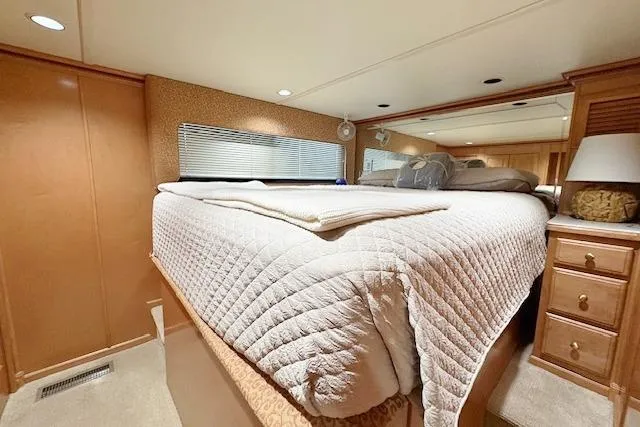 Slide: The Image of Luxurious bedroom interior of 2007 Sumerset 18x86 houseboat with cozy bedding and wooden furnishings. - 6