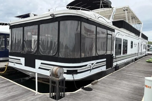 The Image of 2007 Sumerset 18x86 houseboat docked, featuring sleek design and spacious upper deck. - 0