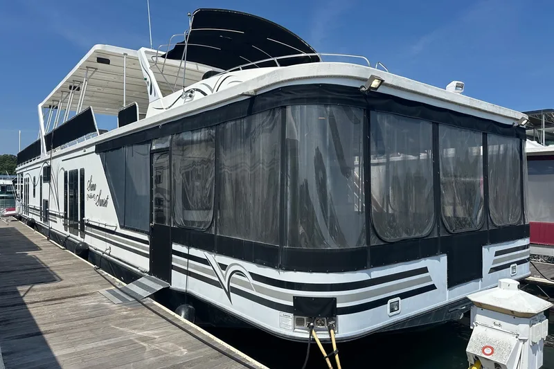 The Image of 2007 Sumerset 18x86 houseboat docked, featuring a sleek design and spacious upper deck. - 0