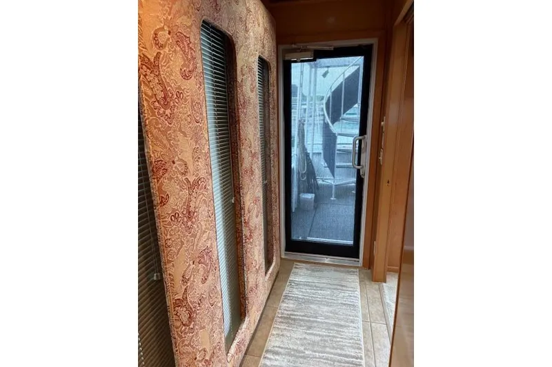 Slide: The Image of Interior hallway of 2007 Sumerset 18x86 houseboat with patterned walls and glass door. - 13