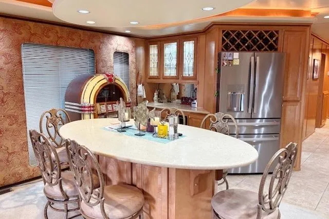 Slide: The Image of Luxurious kitchen in a 2007 Sumerset 18x86 houseboat with island, jukebox, and stainless steel fridge. - 5