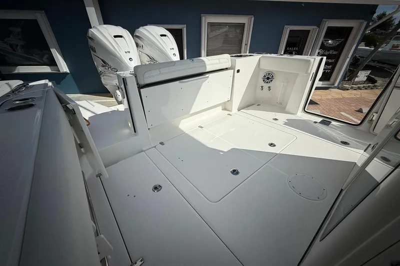 Slide: The Image of 2022 Edgewater 340CC boat deck with twin Yamaha V8 engines, showcasing spacious layout. - 14