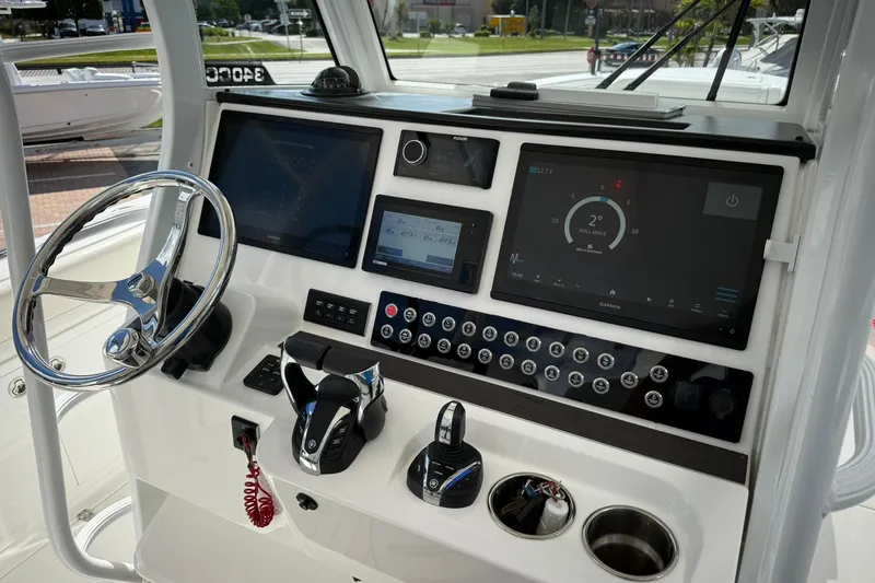 Slide: The Image of 2022 Edgewater 340CC boat dashboard with advanced navigation and control systems. - 29